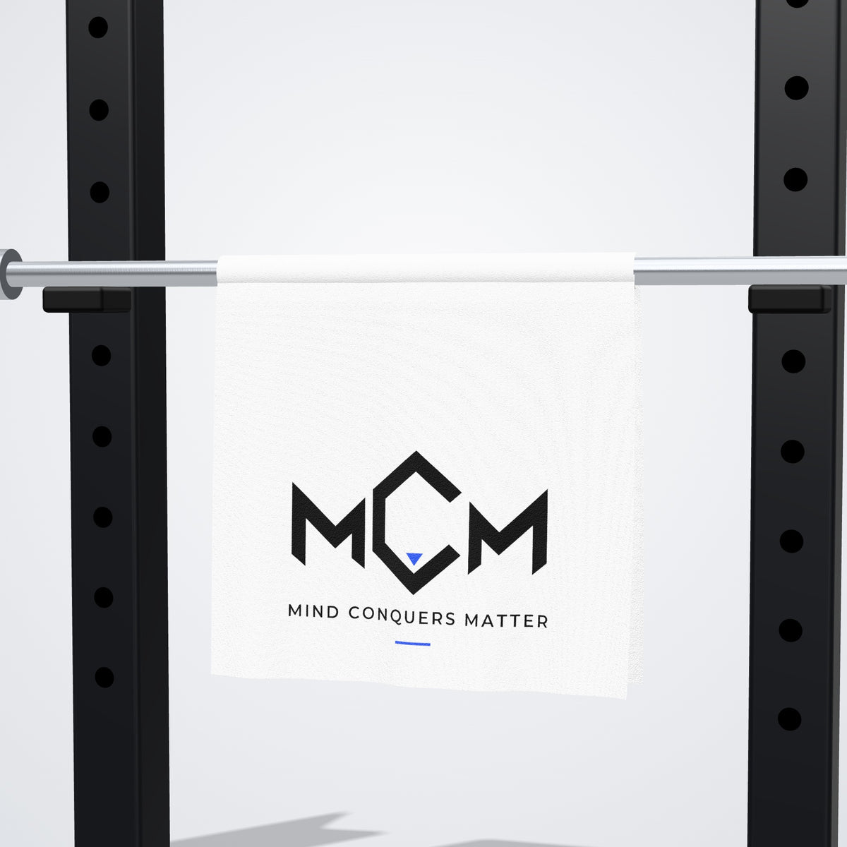 MCM Gym Towel hanging on a barbell rack
